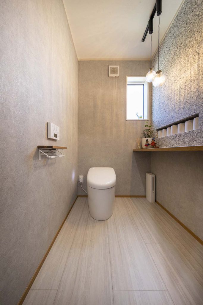 通常より広いサイズのトイレ空間。遊び心のある壁紙でトイレタイムが特別な時間に